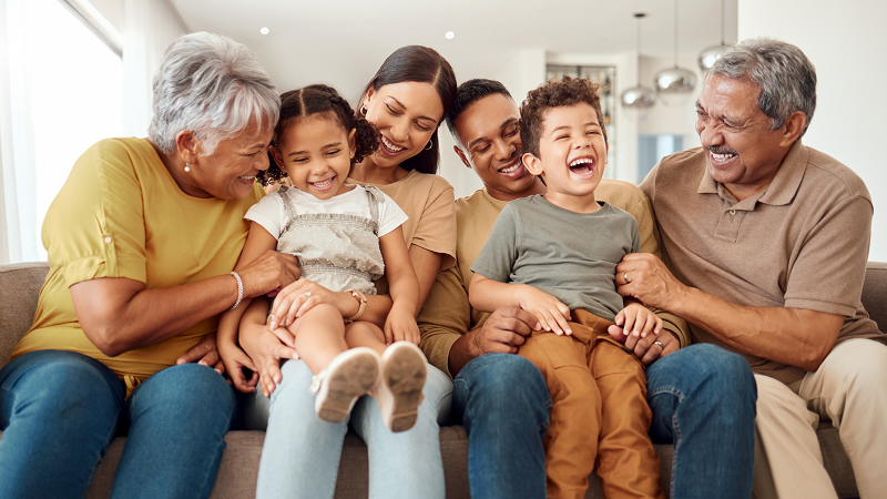 Three generations sitting together on couch