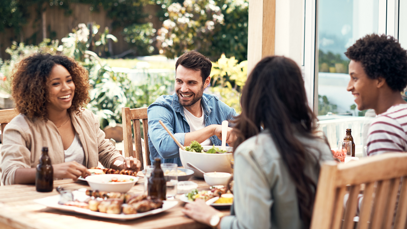 four colleagues dining outdoors