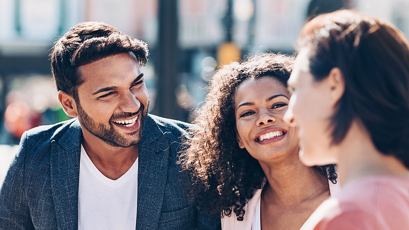 Three colleagues outdoors in urban environment